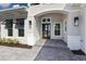 Beautiful home featuring a covered front entrance with steps and a gray brick walkway at 8364 Sea Glass Ct, Sarasota, FL 34240