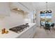Kitchen with stainless steel appliances and a gas stove top, adjacent to the breakfast nook and view of the pool at 8364 Sea Glass Ct, Sarasota, FL 34240