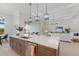 Modern kitchen with a large island, quartz countertops, stainless steel appliances, and seamless access to the living area at 8364 Sea Glass Ct, Sarasota, FL 34240