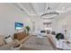 Bright living room with coffered ceilings, modern lighting, and comfortable seating arrangement at 8364 Sea Glass Ct, Sarasota, FL 34240