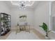 Bright office space featuring a modern glass desk, comfortable chair, and stylish decor at 8364 Sea Glass Ct, Sarasota, FL 34240