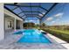 Beautiful in-ground pool with a screened enclosure and a view of the backyard at 8364 Sea Glass Ct, Sarasota, FL 34240