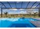 Gorgeous in-ground pool inside of screened lanai with views of an open backyard at 8364 Sea Glass Ct, Sarasota, FL 34240