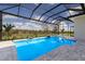 A refreshing screened-in pool has a beautiful water view and easy access to the yard at 8364 Sea Glass Ct, Sarasota, FL 34240