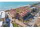 Stunning aerial view of the beachside condo complex with lush landscaping and beachfront access at 8710 Midnight Pass Rd # 501B, Sarasota, FL 34242