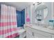 Charming bathroom with blue tile and whimsical pink flamingo decor creating a fun, vibrant atmosphere at 8710 Midnight Pass Rd # 501B, Sarasota, FL 34242