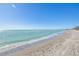 Beautiful beach with gentle waves lapping the shore, creating a tranquil coastal ambiance for residents at 8710 Midnight Pass Rd # 501B, Sarasota, FL 34242