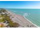 Stunning beachfront view showcasing the beautiful coastline and crystal-clear waters of the area at 8710 Midnight Pass Rd # 501B, Sarasota, FL 34242