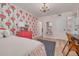 Bedroom with floral wallpaper, a chandelier, a comfortable twin bed, and a cozy, colorful rug at 8710 Midnight Pass Rd # 501B, Sarasota, FL 34242