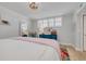 Bedroom featuring a queen-size bed, large window, shutters, and a colorful tropical rug at 8710 Midnight Pass Rd # 501B, Sarasota, FL 34242