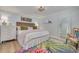 Cozy bedroom featuring a queen size bed, tropical rug, unique decor, and a view into another room at 8710 Midnight Pass Rd # 501B, Sarasota, FL 34242