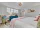 Bedroom featuring a queen-size bed, large window, shutters, and a colorful tropical rug at 8710 Midnight Pass Rd # 501B, Sarasota, FL 34242