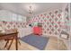 Bedroom with floral wallpaper, a chandelier, a comfortable twin bed, and a cozy, colorful rug at 8710 Midnight Pass Rd # 501B, Sarasota, FL 34242