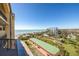 Balcony view showing a well maintained lawn, bocce ball court, beach and ocean views at 8710 Midnight Pass Rd # 501B, Sarasota, FL 34242