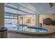 Indoor hot tub and relaxation area featuring comfortable seating and an accessible entryway to outside at 8710 Midnight Pass Rd # 501B, Sarasota, FL 34242
