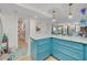 Bright kitchen featuring blue cabinets, countertops, and island with pendant lighting and views into the living room at 8710 Midnight Pass Rd # 501B, Sarasota, FL 34242