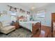 Bright bedroom with a wooden bed frame, natural lighting, and hardwood floors at 9408 69Th E Ave, Palmetto, FL 34221