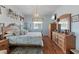Comfortable bedroom with a dresser, hard wood floors, and a quaint chandelier at 9408 69Th E Ave, Palmetto, FL 34221