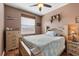 Comfortable bedroom featuring a queen bed, ceiling fan and warm, neutral tones at 9408 69Th E Ave, Palmetto, FL 34221