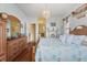 Cozy bedroom with a wooden bed frame, dresser, and an ensuite bathroom view at 9408 69Th E Ave, Palmetto, FL 34221