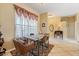 Dining area with a table and four chairs, bright window and elegant decor at 9408 69Th E Ave, Palmetto, FL 34221