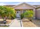 Inviting home entrance with decorative shrubs, trees, and a well-manicured lawn with a paved walkway to the door at 9408 69Th E Ave, Palmetto, FL 34221