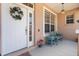 Charming front porch with seating, a decorative wreath, and a hanging lantern for a welcoming appeal at 9408 69Th E Ave, Palmetto, FL 34221