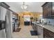 Well-lit kitchen featuring stainless steel appliances, tile flooring, granite countertops and dark wooden cabinets at 9408 69Th E Ave, Palmetto, FL 34221