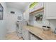 Convenient laundry room with a washer, dryer, storage cabinets and a folding counter at 9408 69Th E Ave, Palmetto, FL 34221