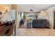Open-concept living area with modern decor, including hardwood floors and a large TV and view into adjacent room at 9408 69Th E Ave, Palmetto, FL 34221