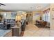 Open-concept living room with a leather sofa and connecting dining area with seating for four at 9408 69Th E Ave, Palmetto, FL 34221