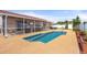 Private swimming pool with outdoor seating and a screened-in lanai, perfect for enjoying the outdoors at 9408 69Th E Ave, Palmetto, FL 34221