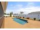 Refreshing backyard pool surrounded by lush landscaping and a privacy fence at 9408 69Th E Ave, Palmetto, FL 34221