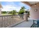 View of a cozy front porch featuring neutral toned gravel, and a white railing and seating area with a turtle decoration at 9408 69Th E Ave, Palmetto, FL 34221