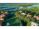 Scenic aerial shot of waterfront golf course homes, vibrant landscaping, and multiple ponds at 9460 Discovery Ter # 202D, Bradenton, FL 34212