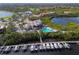Expansive aerial view showcasing a community clubhouse, pool, waterfront homes, and convenient boat docks at 9460 Discovery Ter # 202D, Bradenton, FL 34212