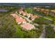Aerial view of community with vibrant homes, golf course, and waterways at 9460 Discovery Ter # 202D, Bradenton, FL 34212