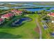 Beautiful aerial view of community homes surrounding a manicured golf course and lakes at 9460 Discovery Ter # 202D, Bradenton, FL 34212