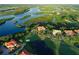 Beautiful aerial view of waterfront golf course homes, lush landscaping, and sparkling waterways at 9460 Discovery Ter # 202D, Bradenton, FL 34212