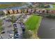 Aerial view of the community highlighting the location of homes with parking and a small lake at 9460 Discovery Ter # 202D, Bradenton, FL 34212