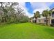 View of a lush lawn in a residential community surrounded by mature trees and landscaping at 9460 Discovery Ter # 202D, Bradenton, FL 34212