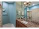 Bathroom with granite countertops, a dark wood cabinet, and a large mirror at 9460 Discovery Ter # 202D, Bradenton, FL 34212