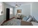 Bright bedroom with a daybed, ceiling fan, and a window overlooking a garden at 9460 Discovery Ter # 202D, Bradenton, FL 34212