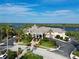 Beautiful aerial view of the clubhouse with manicured landscaping and lake views at 9460 Discovery Ter # 202D, Bradenton, FL 34212