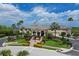 Well-maintained clubhouse entrance features manicured landscaping, elegant stairs, and a welcoming porte cochere at 9460 Discovery Ter # 202D, Bradenton, FL 34212