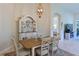 This dining room features a wooden table, matching chairs, overhead lighting, and a quaint hutch at 9460 Discovery Ter # 202D, Bradenton, FL 34212