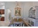 Elegant dining room boasts a wooden table, chairs, hutch and a captivating painting at 9460 Discovery Ter # 202D, Bradenton, FL 34212