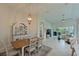 Open floor plan view of dining and living room showcasing natural light and tile flooring at 9460 Discovery Ter # 202D, Bradenton, FL 34212