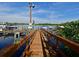 Picturesque wooden dock extending into tranquil waters, providing convenient boat access and serene views at 9460 Discovery Ter # 202D, Bradenton, FL 34212