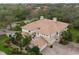 Stunning aerial view of home with tile roof, lush landscaping, and brick driveway at 9460 Discovery Ter # 202D, Bradenton, FL 34212